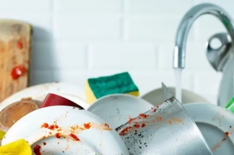 kitchen sink full of dirty dishes