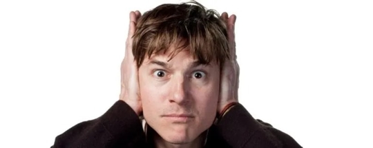 A person with hands over their ears.