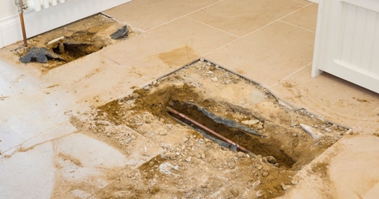 Exposed pipework under tile floor