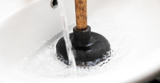 The plunger clears the clogged sink drain