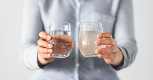 Woman holding clean and dirty water