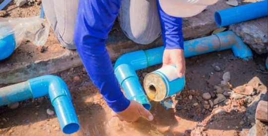 A plumber fixing a pipe
