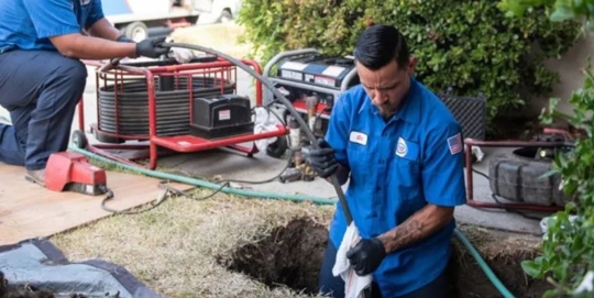 A plumber fixing a pipe