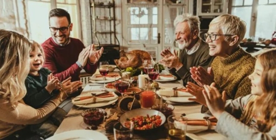A happy family having a Thanksgiving dinner