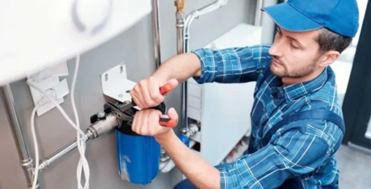 A plumber fixing a pipe