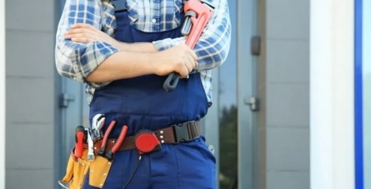 A plumber holding a wrench
