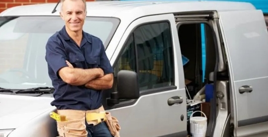 A plumber smiling at the camera