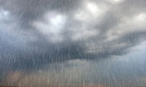 Dark, ominous clouds fill the sky as rain falls.