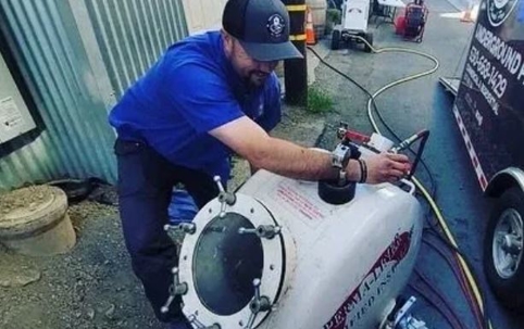 man fixes trenchless sewer