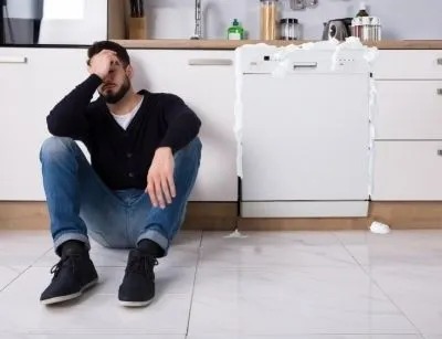 A man sitting next to a sink