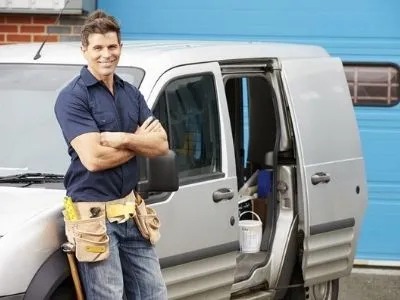 A plumber is smiling at the camera