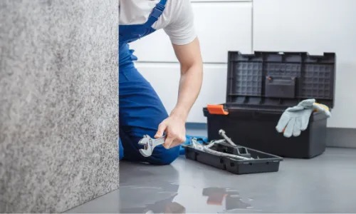A plumber fixing something