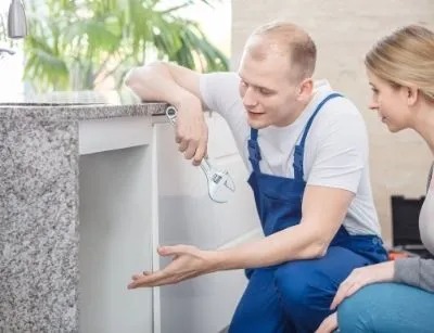 A plumber explaining the problem of the sink to the owner