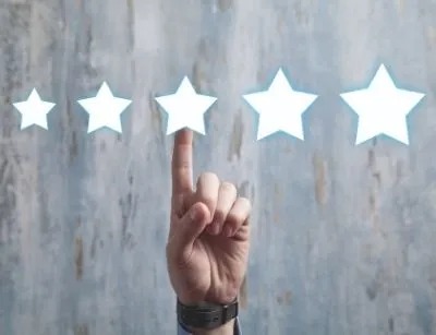 A person's hand pointing stars