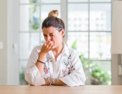 A picture of a woman covering her nose