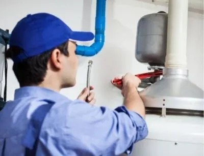 A plumber fixing a water heater