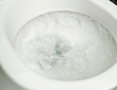 A picture of a flushing toilet