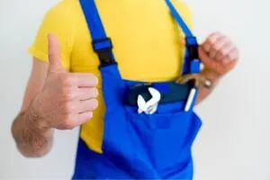 A plumber giving a thumbs-up gesture.